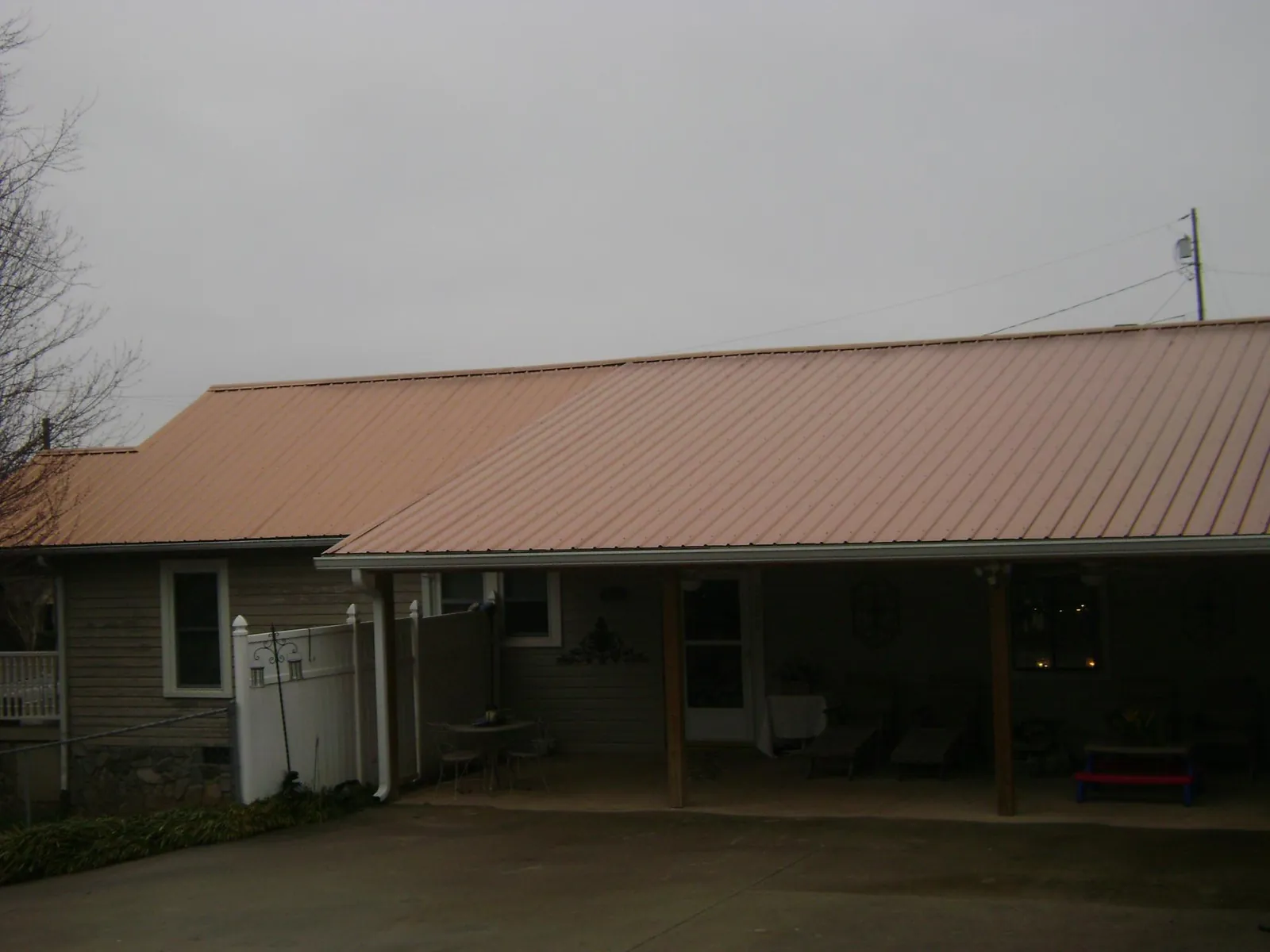 Copper toned metal roof over a wide covered patio in Arnoldsburg